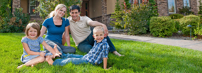 Family on Grass in Front of Home